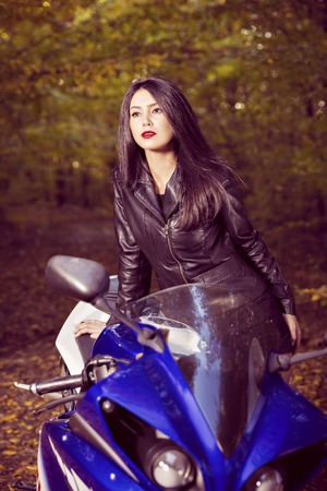 Beautiful Biker girl on a motorcycleの写真素材