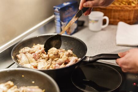 pan with chicken wings on the stoveの写真素材