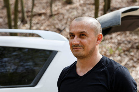 Closeup of a handsome mature caucasian man outdoor in the forest