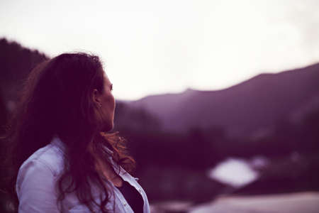 Closeup of a beautiful hispanic woman outdoor near a pine forest and mountainsの写真素材