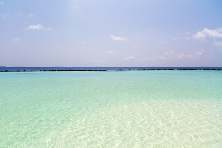 Beautiful island beach with sandspit at Maldivesの写真素材