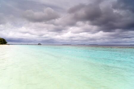 Beautiful island beach with sandspit at Maldivesの写真素材