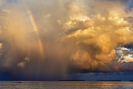 rainbow beautiful seaside at the time of sunset, storm cloudsの写真素材