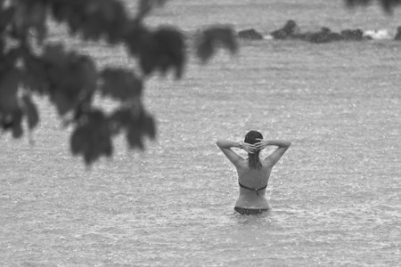 people enjoying a warm rain in ocean