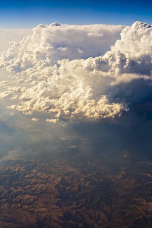 mountain seen through clouds from an airplaneの写真素材