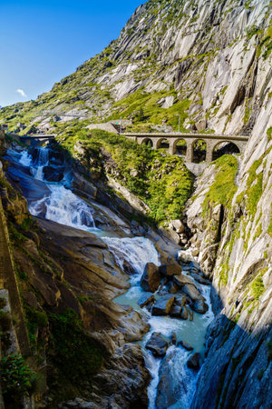 Waterfall on rocky mountains in Switzerlandの写真素材