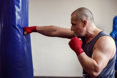 strong man doing workout in the boxing hall