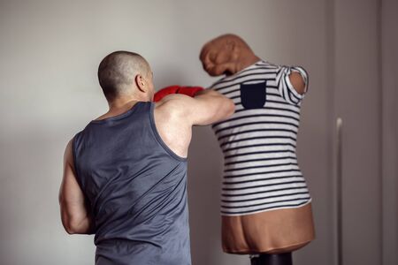 strong man doing workout in the boxing hallの写真素材