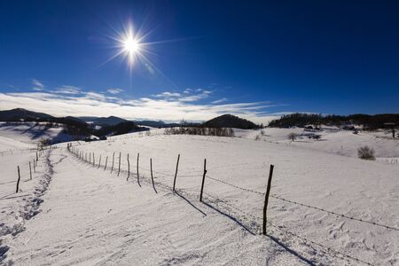 beautiful landscape with the sun shining winter day in the mountainsの写真素材