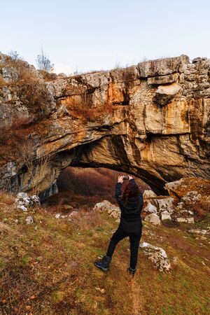 woman tourist traveling through Romania. God's Bridgeの写真素材