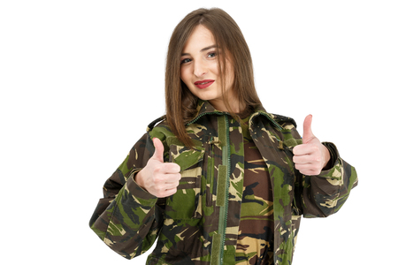 young woman soldier in military camouflage outfit showing peace sign, okの写真素材