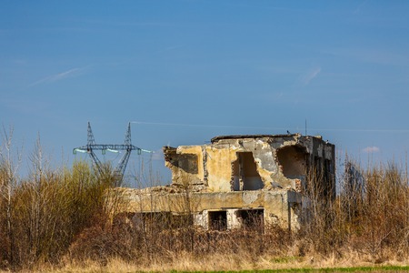 ruins of abandoned buildings surrounded by vegetationの写真素材