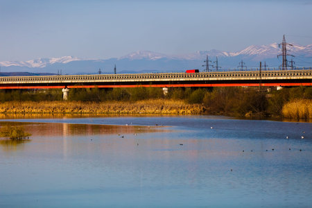 bridge over the river with mountains in the background
