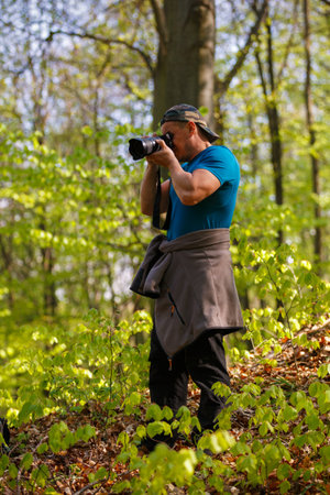 tourist photographing the forest in spring day