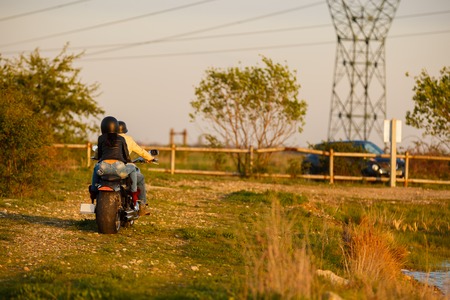 Beautiful young couple with a classic motorcycleの写真素材