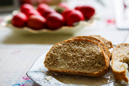 Bread cut slices and red eggs on a table
