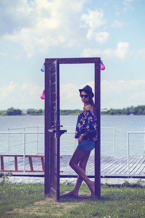 Portrait with a woman at a door near the lakeの写真素材