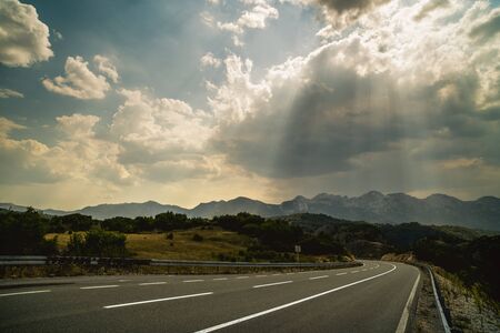 Landscape with a mountain road on summer dayの写真素材