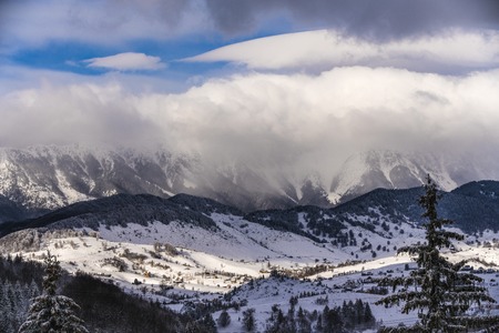 Beautiful winter landscape with Carpati Piatra Craiului mountains in Romaniaの写真素材