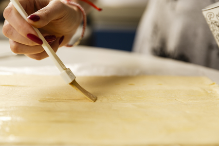 Woman preparing a pastry at home in the kitchenの写真素材