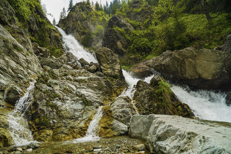Landscape with a big waterfall in the mountainsの写真素材