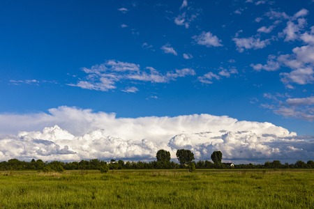 Beautiful landscape with a cloud of clouds above a fieldの写真素材