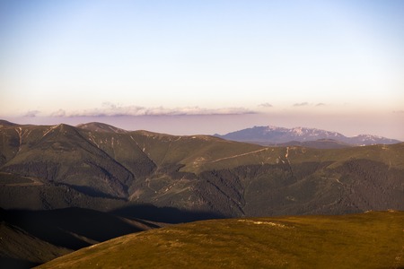Summer landscape with high mountains and clouds in a summer dayの写真素材