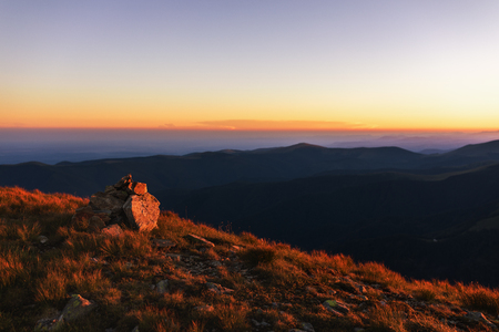 Landscape with beautiful sunset on top of the mountainsの写真素材