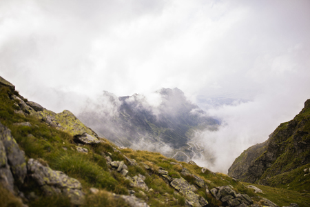 Summer landscape with high mountains and clouds in a summer dayの写真素材