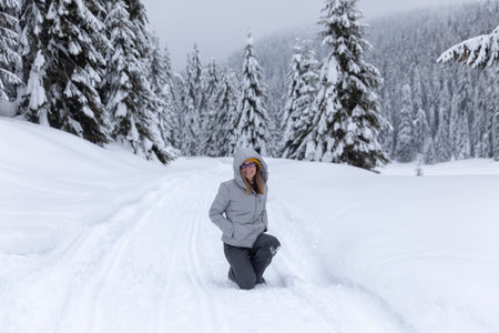 Hapopy tourist lady in her winter holiday in the mountains