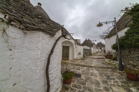 ALBEROBELLO, APULIA, ITALY - FEBRUARY 03 - Beautiful view of the traditional trulli houses with their conical roof on february 03, 2019 in Alberobelloのeditorial素材