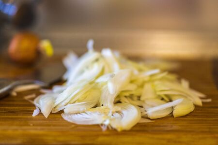 Raw chopped onion on a wooden tableの写真素材