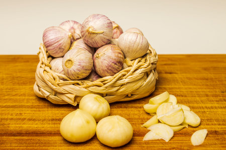 garlic solo in a wicker basket on a wooden Board on a linen background.