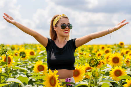 Young beautiful woman near water, smiling in summer dayの写真素材