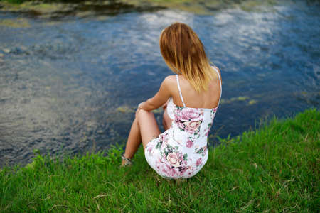 Pretty young woman on a sunflowers fieldの写真素材
