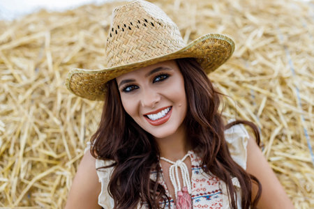 Beautiful cowboy woman Posing near at the haystacks, Fashion concept.の写真素材