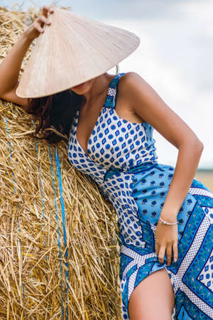 Beautiful cowboy woman Posing near at the haystacks, Fashion concept.の写真素材