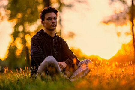 Young handsome man outdoors in fall clothing with autumn natural surroundings