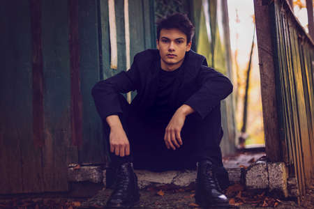 Portrait with a handsome young man in autumn forest, fashion concept.の写真素材