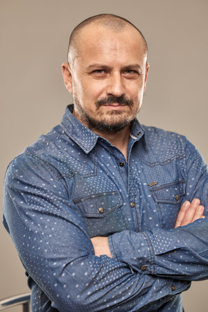 Closeup of a handsome caucasian man with arms foldedの写真素材