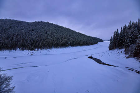 landscape with a mountain river in winterの写真素材