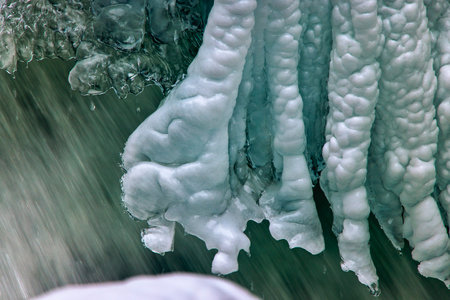 Beautiful ice formations on a mountain river in winter, close up.