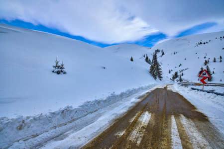 winter road and trees with snow and Carpathian Mountains landscape.の写真素材