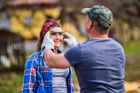 a man protects his woman by wearing glasses.の写真素材