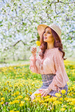Beautiful natural woman in the garden of apple
