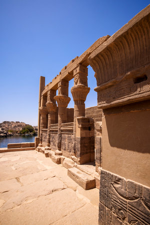 Edfu, ASWAN, EGYPT - 24 April 2021:  Temple of Isis at Philae island, in Lake Nasser, with bas-reliefs of Isis, Horus and the pharaoh.のeditorial素材