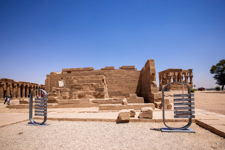 Edfu, ASWAN, EGYPT - 24 April 2021:  Temple of Isis at Philae island, in Lake Nasser, with bas-reliefs of Isis, Horus and the pharaoh.のeditorial素材