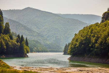 landscape with a mountain lake on a hot summer dayの写真素材