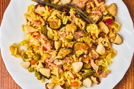 Paella plate with tuna and Brazil nuts.