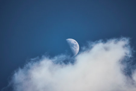 the moon in the blue sky with clouds at duskの写真素材
